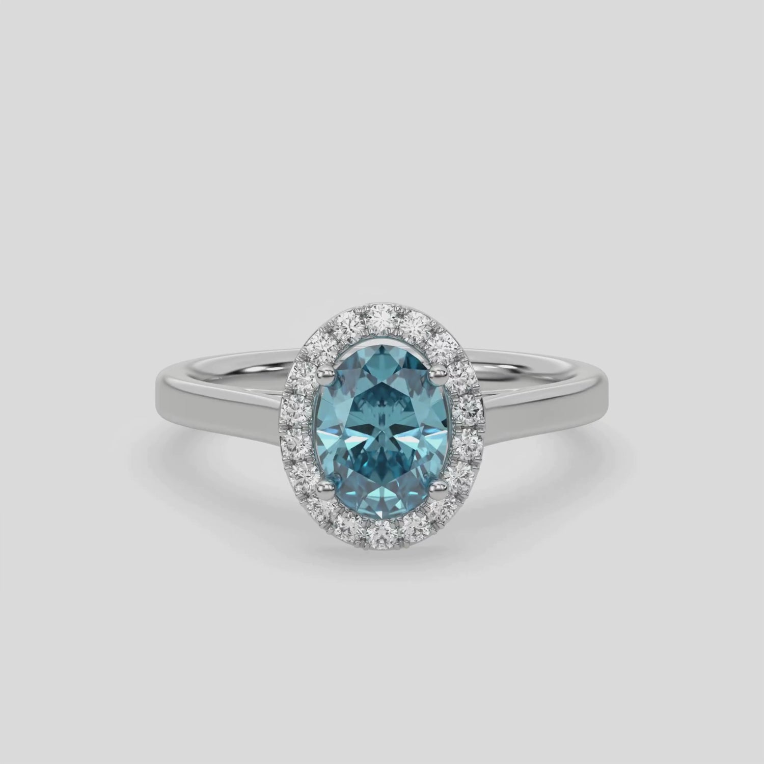 This video features a white gold ring is made with an fancy Blue oval solitaire diamond set in a four-prong setting