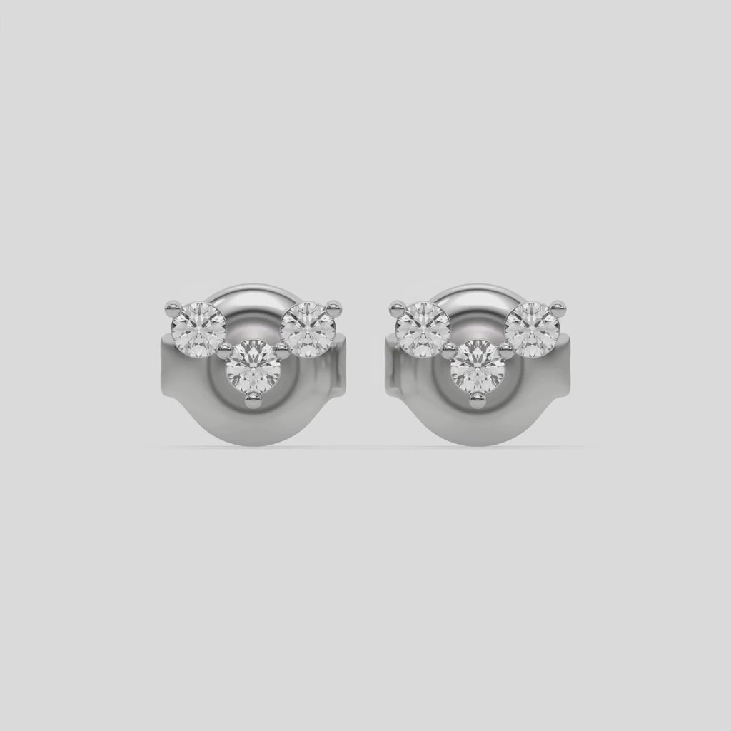 This video features a white gold Trio Diamond Earrings made using three round brilliant-cut diamonds creating a v shaped design, securely set in prong setting