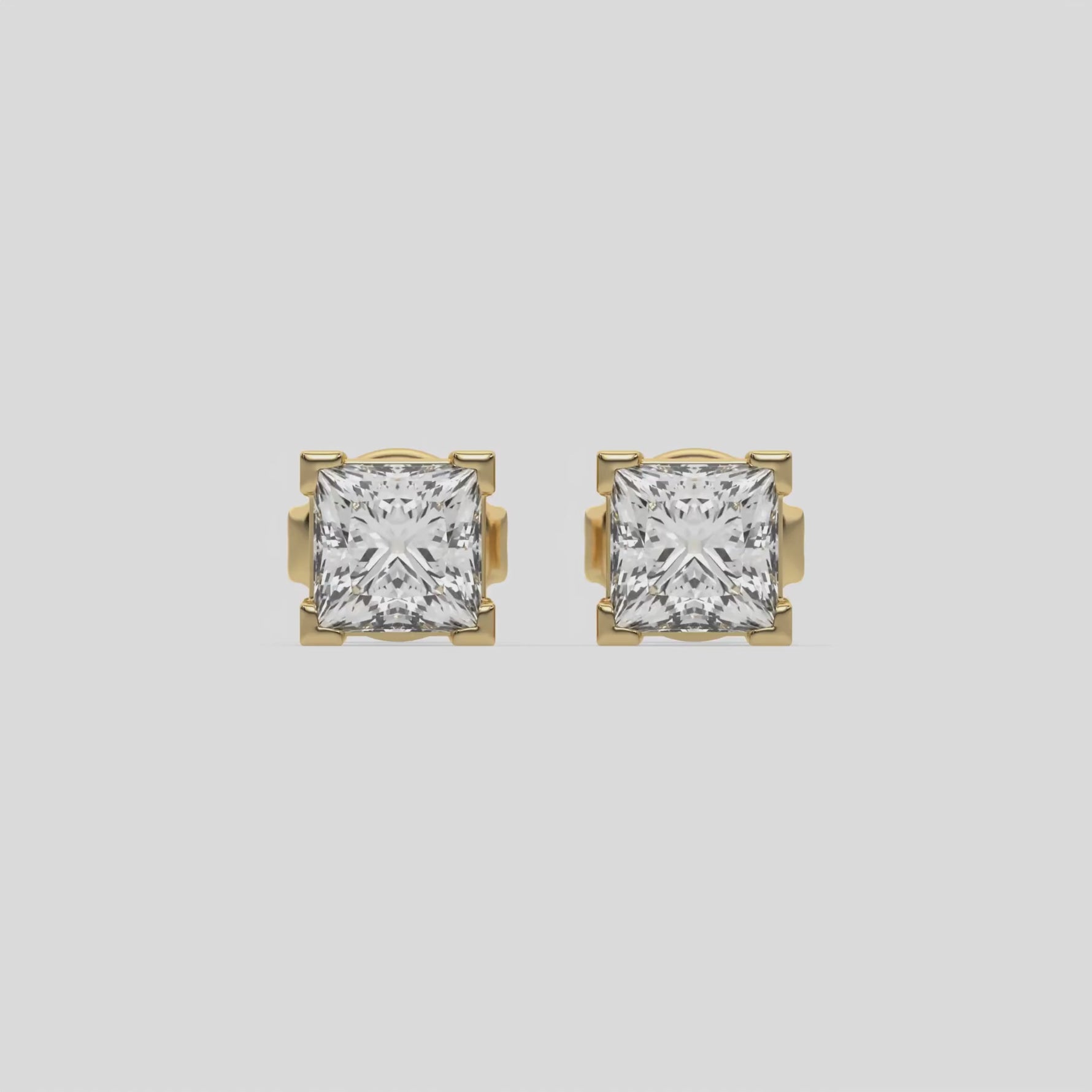 18k yellow gold Princess Diamond Earrings made with a princess cut diamonds set in a four v prong setting