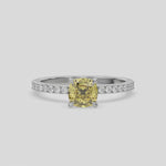 This video features a white gold ring is made with a fancy Yellow cushion solitaire diamond set in four-prong setting