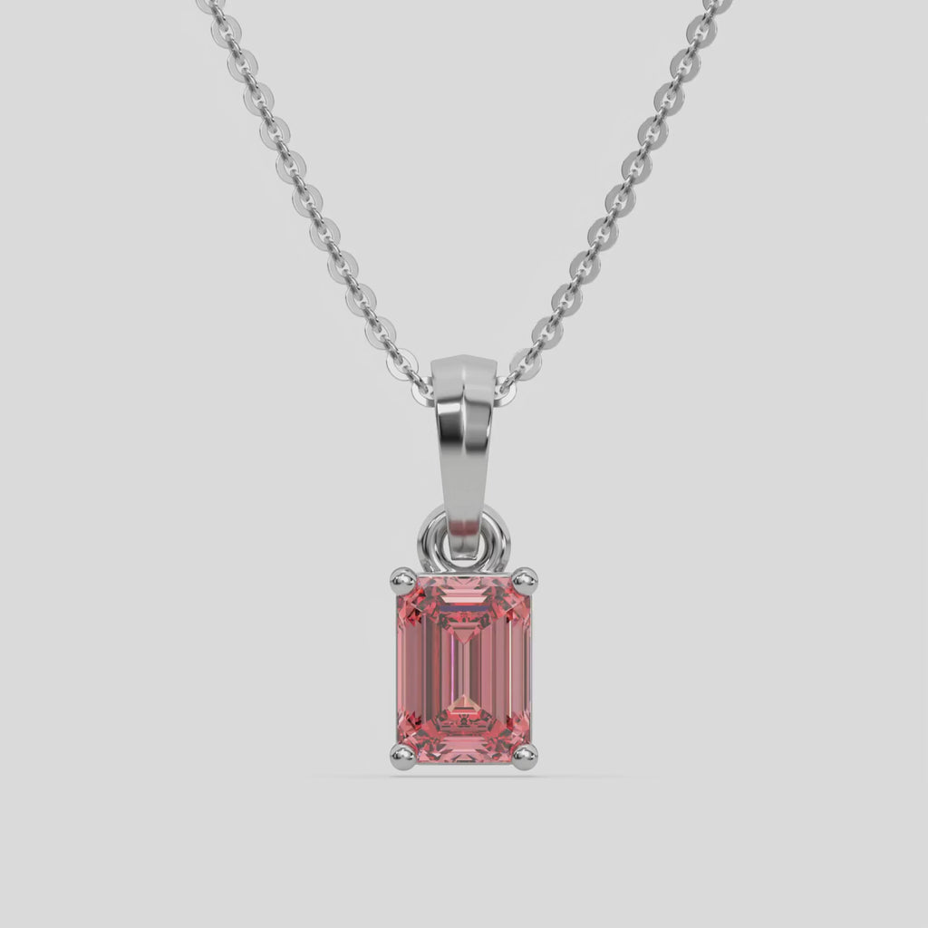 This white gold Fancy Pink Emerald Solitaire Diamond Necklace made with an fancy Pink emerald cut diamond in a four prong setting with adjustable chain 