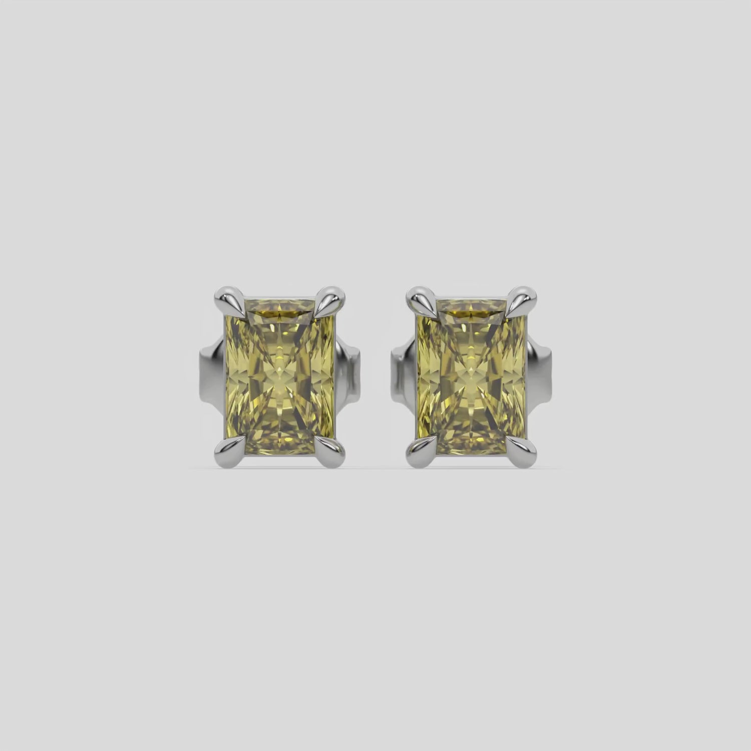 This video features a white gold Classic Radiant Diamond Earrings made with a fancy yellow radiant-cut diamonds set in a four prong setting