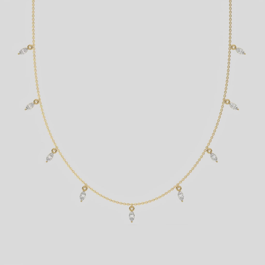 Marquise Dangling Diamond Necklace made with nine marquise cut diamonds each set in a prong setting, distributed evenly along the chain