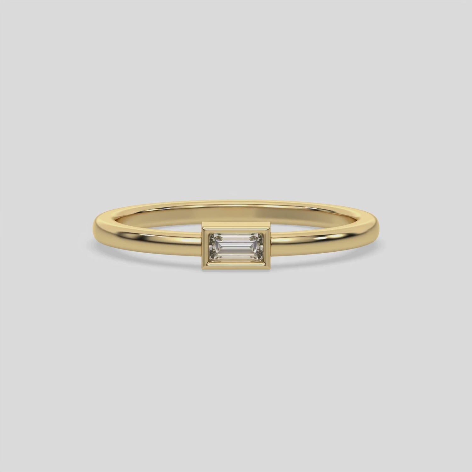 This video features a Thin yellow gold band with a baguette solitaire diamond in bezel setting