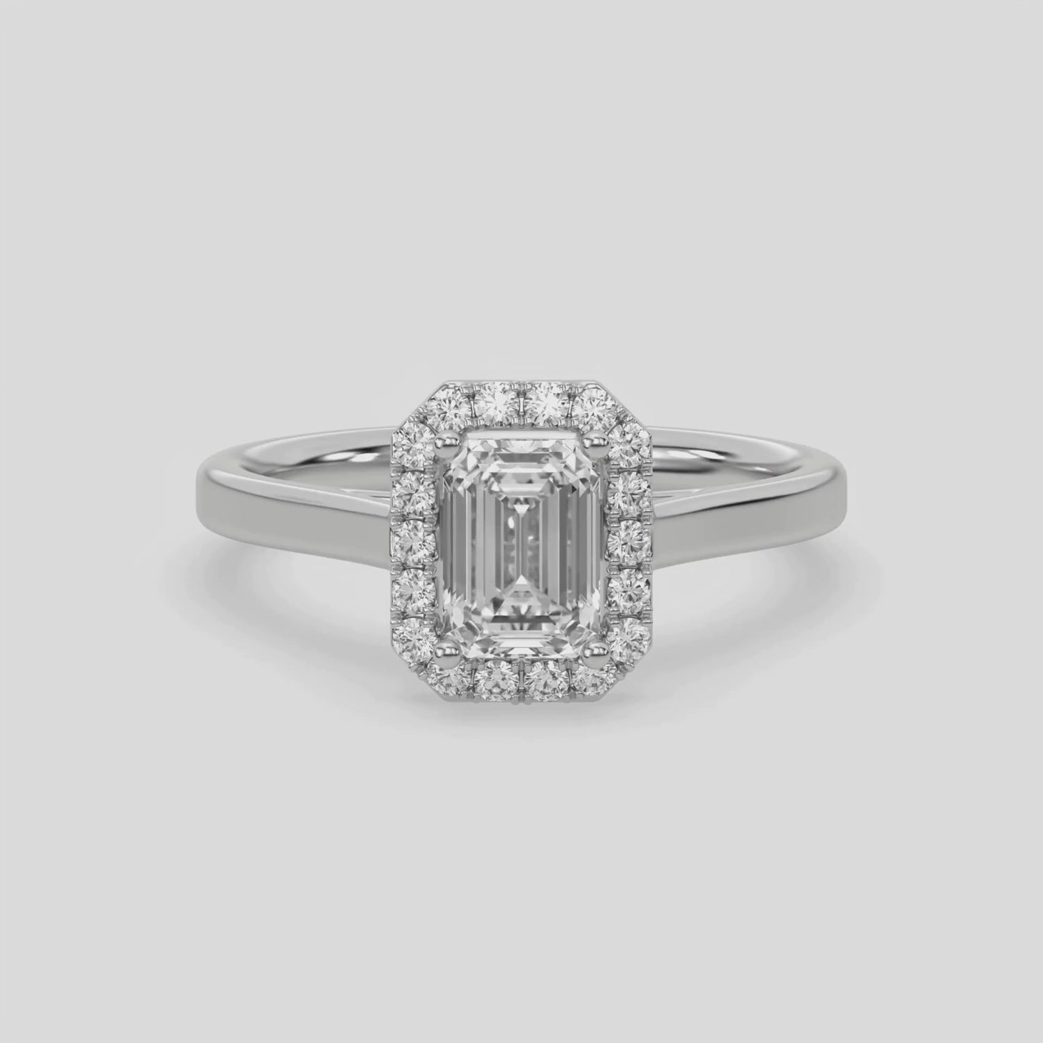 This video features a white gold ring is made with an emerald solitaire diamond set in a four-prong setting 