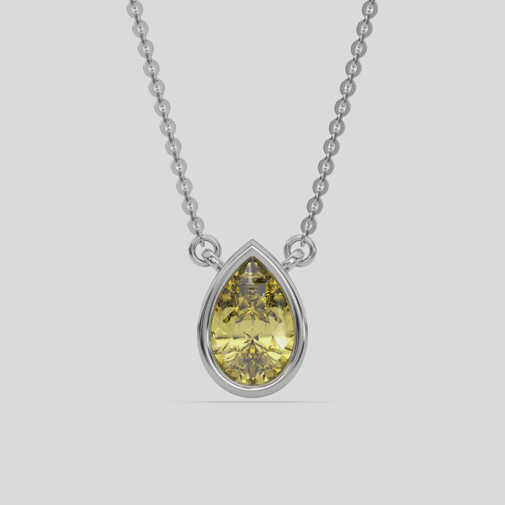 This white gold Fancy Yellow Pear Solitaire Diamond Necklace made with a fancy yellow pear cut diamond in bezel setting with adjustable chain 