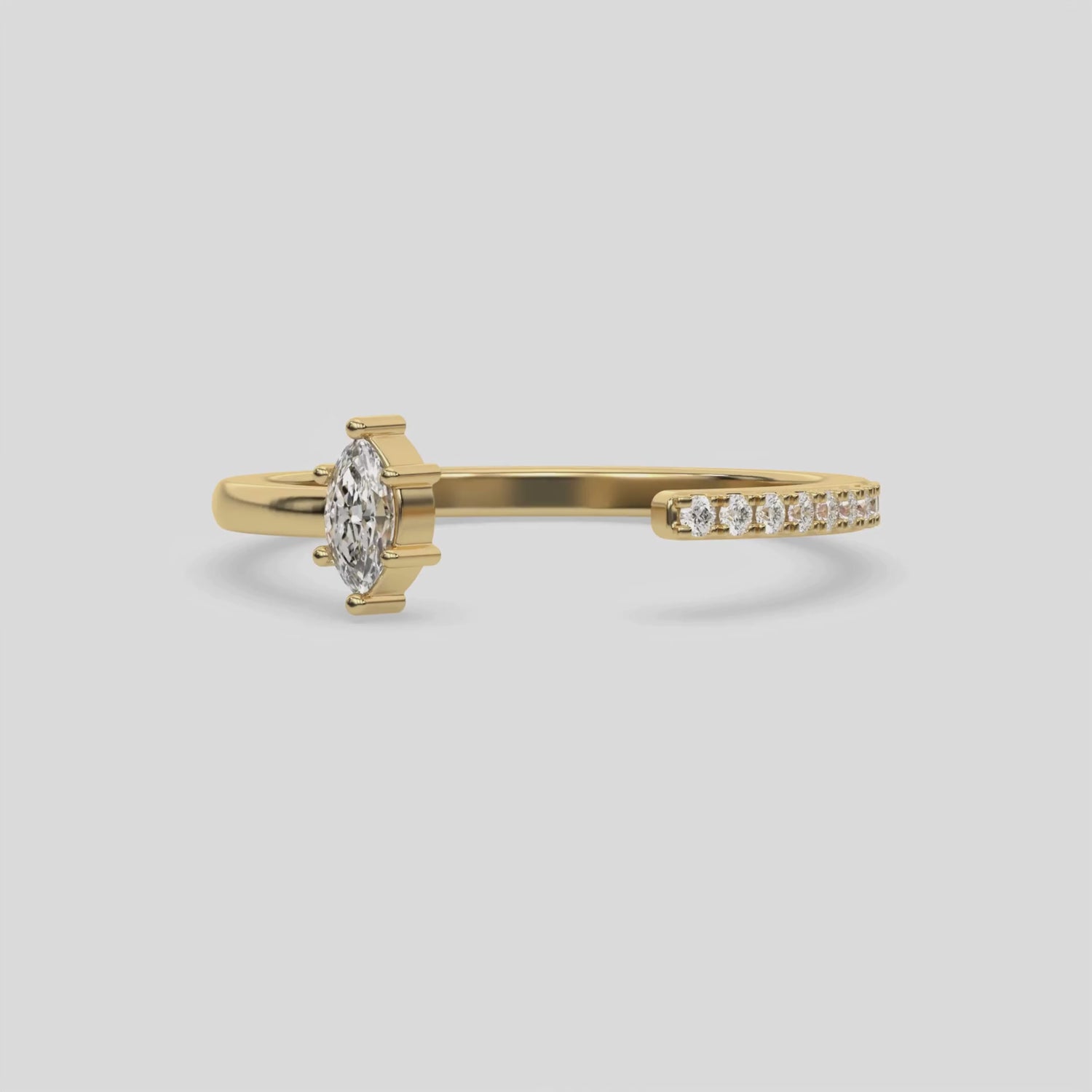 This video features a yellow gold Open Marquise Diamond ring features an open gap in the center. One side with a 0.15 CT marquise solitaire in a six prong setting, while the other side sparkles with 9 round brilliant-cut diamonds set in a micro-pave setting