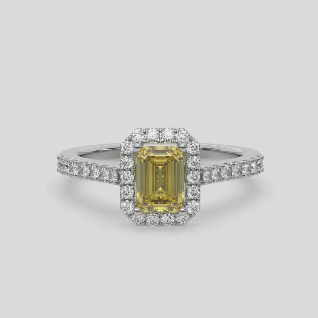 This video features a white gold Emerald Diamond Halo Engagement Ring is made with a fancy yellow emerald solitaire diamond set in a four-prong setting