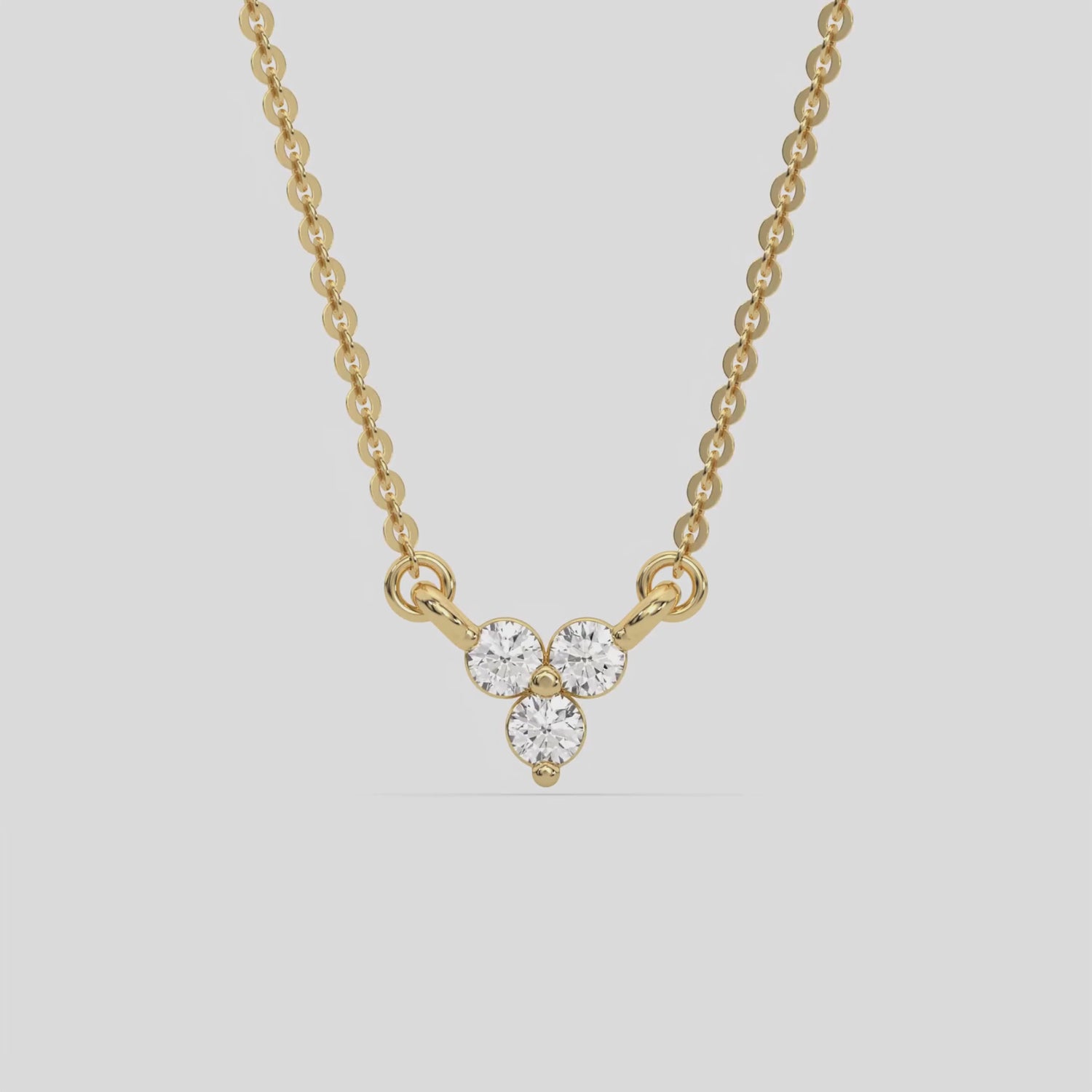 This yellow gold Trio Diamond Necklace made with three round brilliant-cut diamonds, securely set in bezel setting 