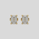 This video features a yellow gold Classic Emerald Diamond Earrings made with an emerald-cut diamonds set in a four prong setting