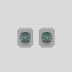 This video features a white gold Classic Radiant Diamond Halo Earrings made with a fancy green radiant cut solitaire diamonds set in a four prong setting