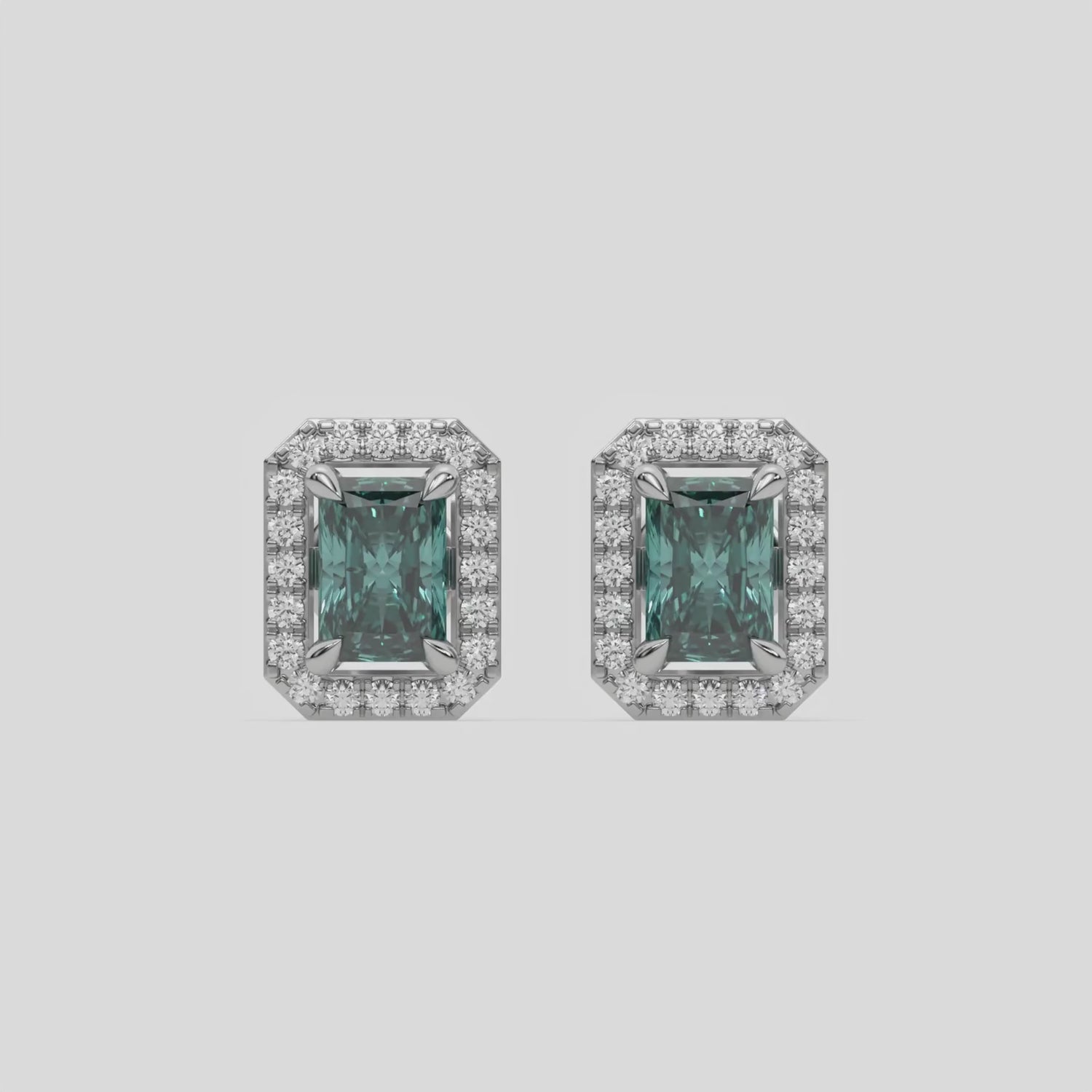 This video features a white gold Classic Radiant Diamond Halo Earrings made with a fancy green radiant cut solitaire diamonds set in a four prong setting