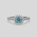 This video features a white gold Cushion Diamond Halo Engagement Ring is made with a fancy Blue cushion solitaire diamond set in a four-prong setting