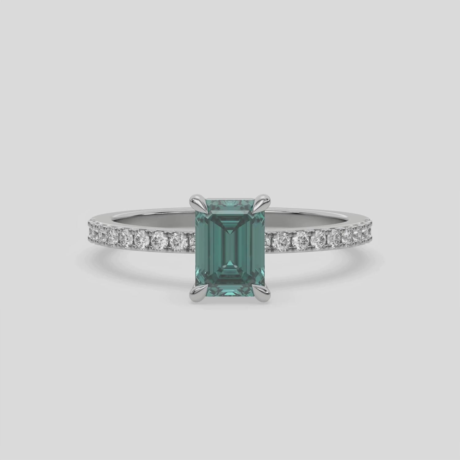 This video features a white gold ring is made with an fancy Green emerald solitaire diamond set in four-prong setting, and is complemented by a round pave diamonds band