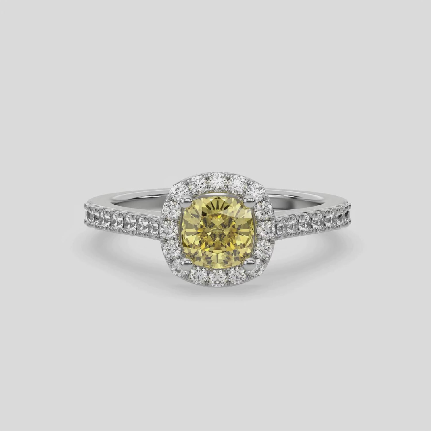 This video features a white gold Cushion Diamond Halo Engagement Ring is made with a fancy Yellow cushion solitaire diamond set in a four-prong setting