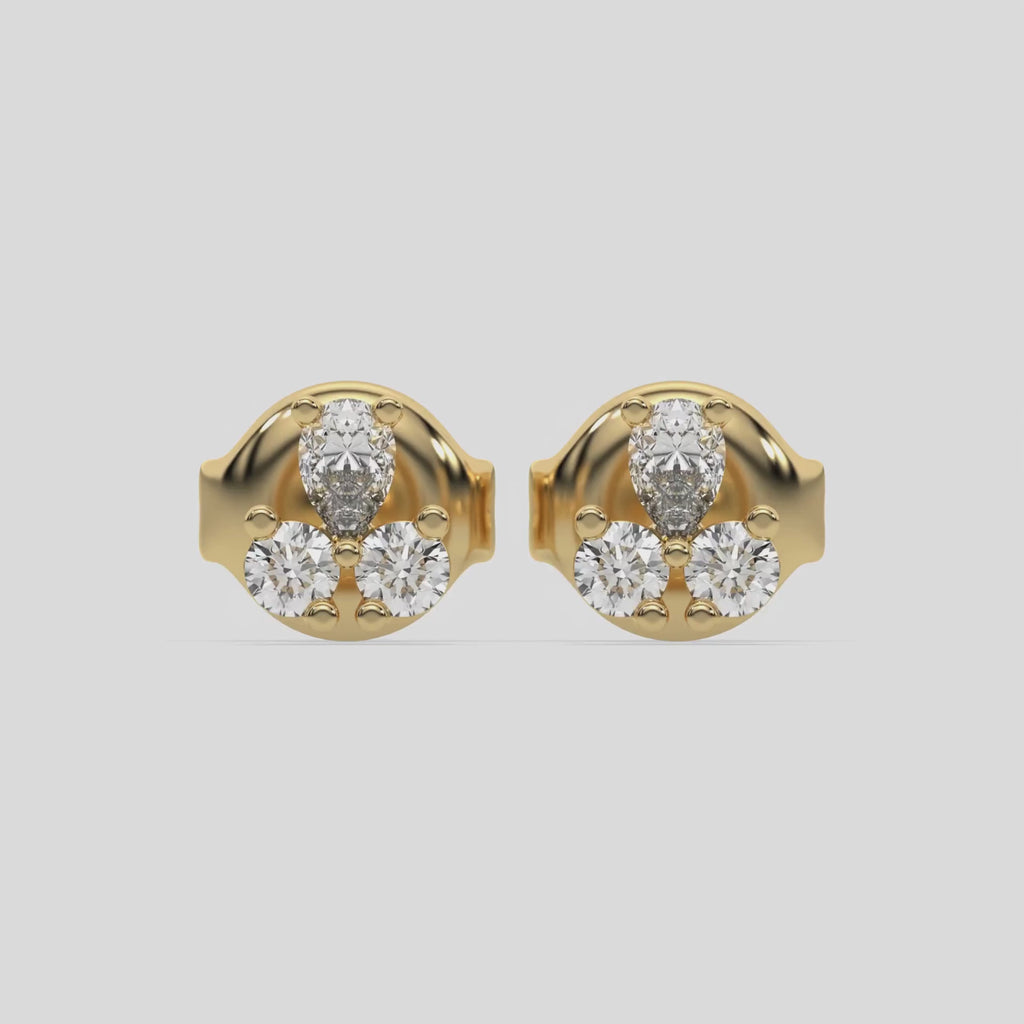 This video features a yellow gold Trio Diamond Earrings made using two round brilliant-cut diamonds and a pear diamond, securely set in prong setting