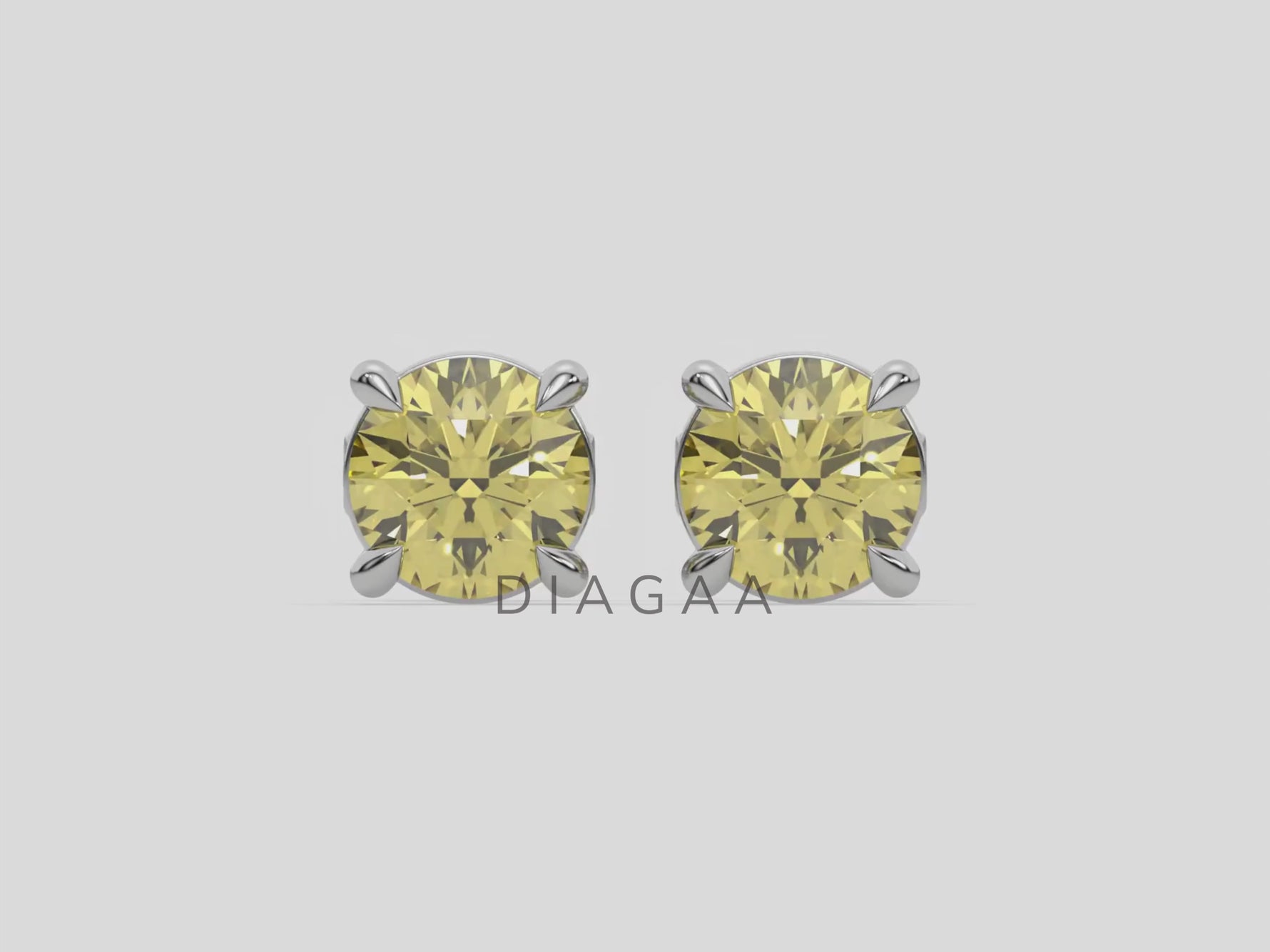 18k white gold Round Diamond Studs made with fancy yellow round brilliant-cut diamonds set in a four prong setting