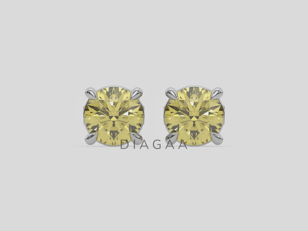 18k white gold Round Diamond Studs made with fancy yellow round brilliant-cut diamonds set in a four prong setting