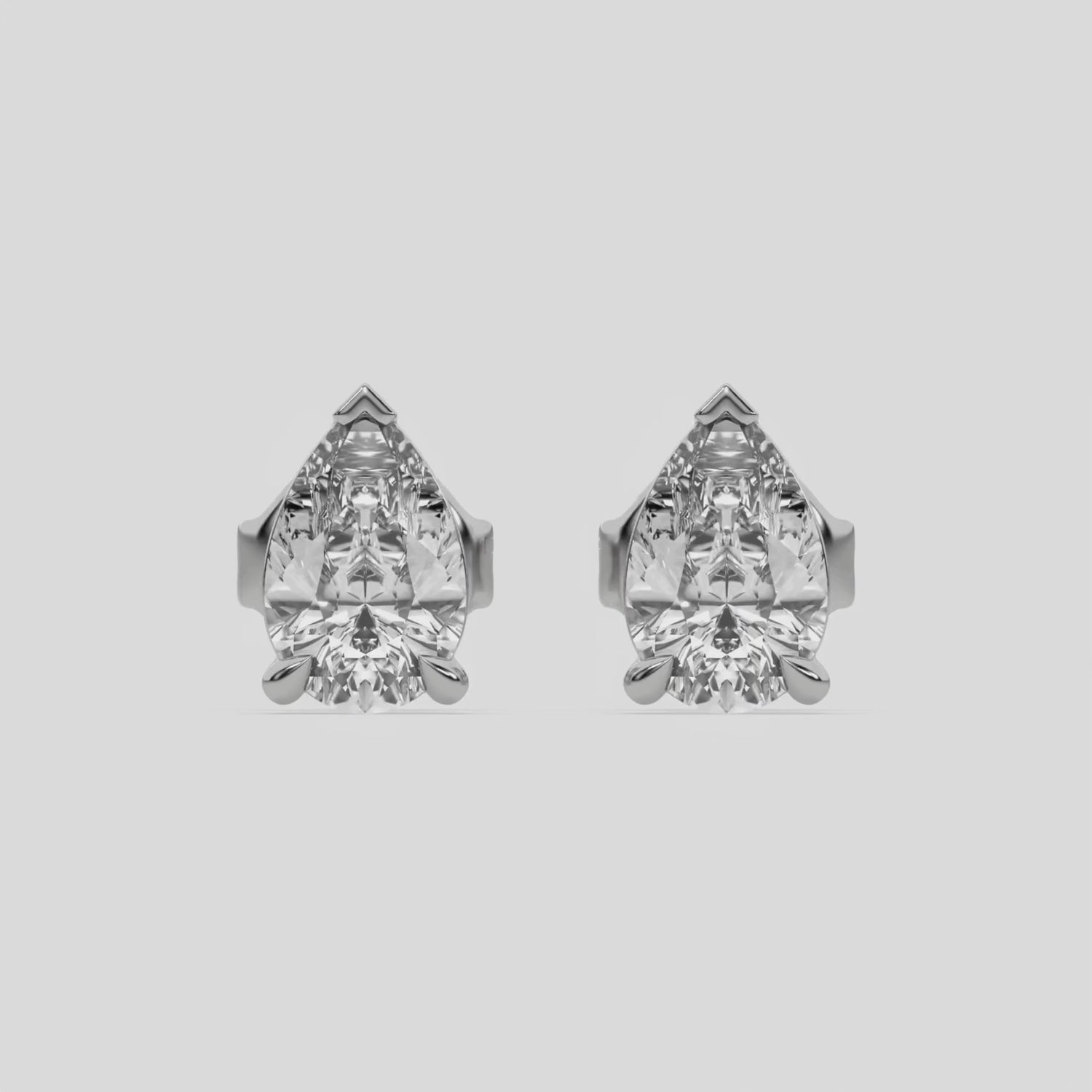 This video features a white gold Classic Pear Diamond Earrings made with a pear-cut diamonds set in a four prong setting