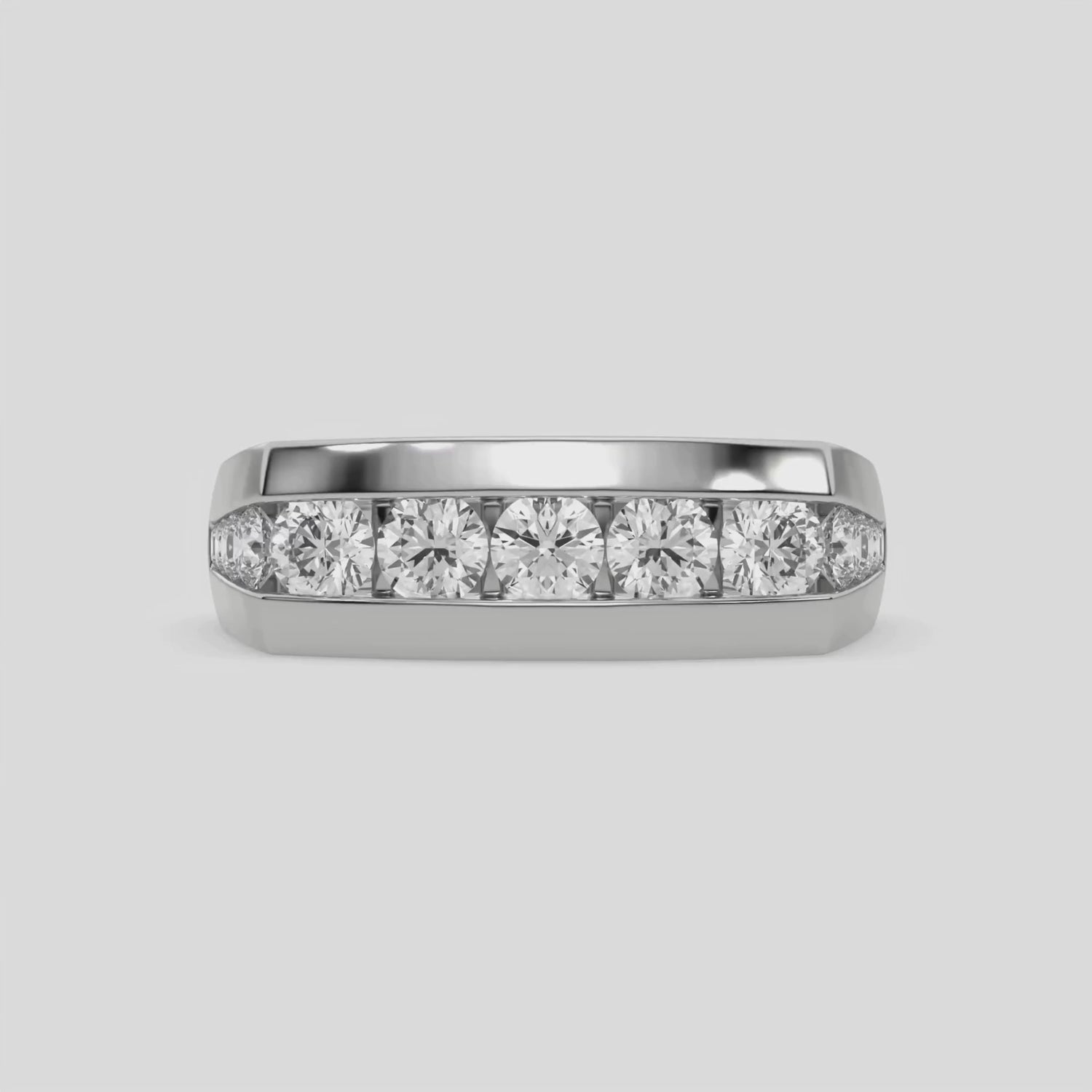 This video features a white gold Men's channel-set diamond ring seamlessly blends solid gold with round brilliant-cut diamonds. The diamonds are expertly placed in a channel setting