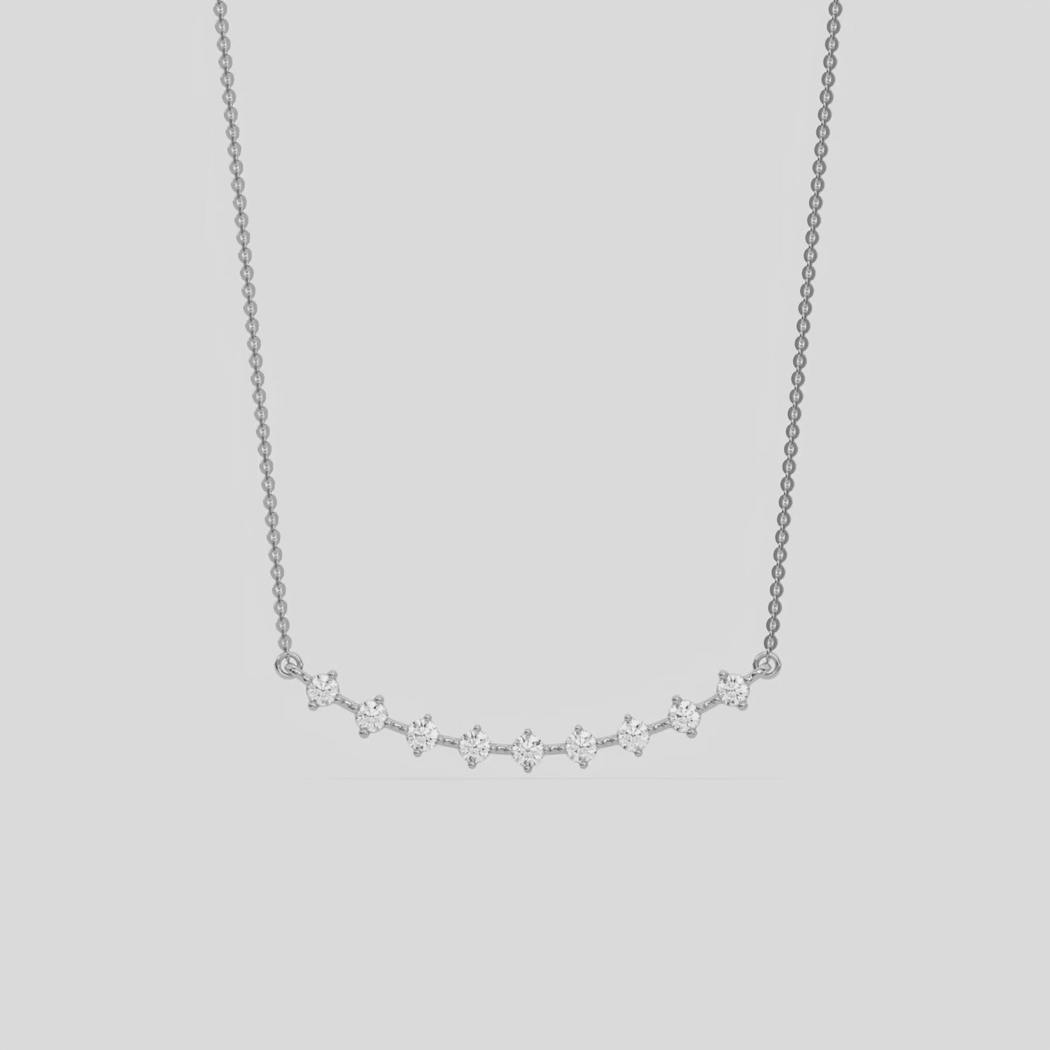 Curved Bar Diamond Necklace made with nine round brilliant-cut diamond in two prong setting with distance between each diamond