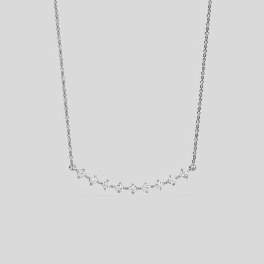 Curved Bar Diamond Necklace made with nine round brilliant-cut diamond in two prong setting with distance between each diamond