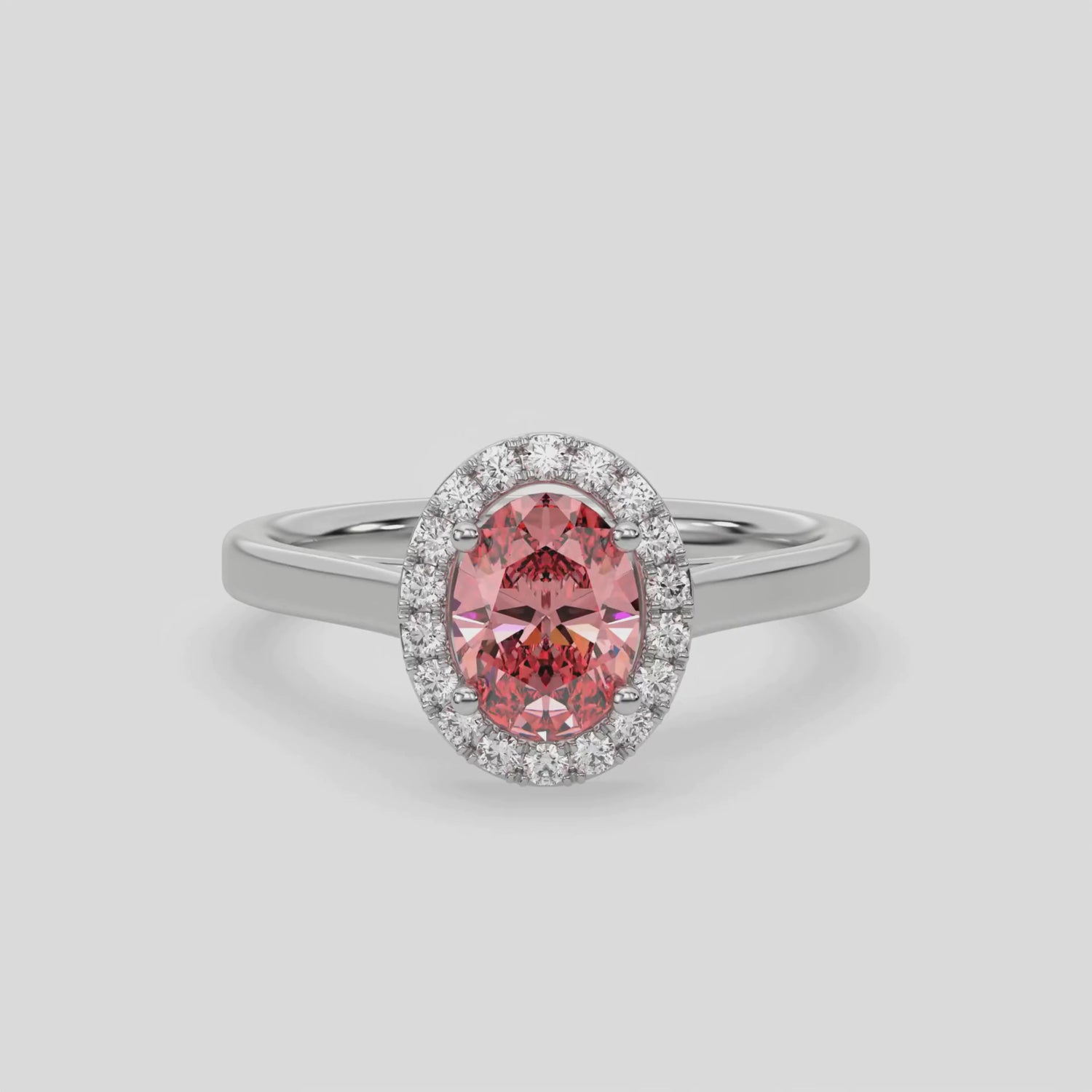 This video features a white gold ring is made with an fancy Pink oval solitaire diamond set in a four-prong setting