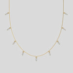 Marquise Dangling Diamond Necklace made with nine marquise cut diamonds each set in a prong setting, distributed evenly along the chain