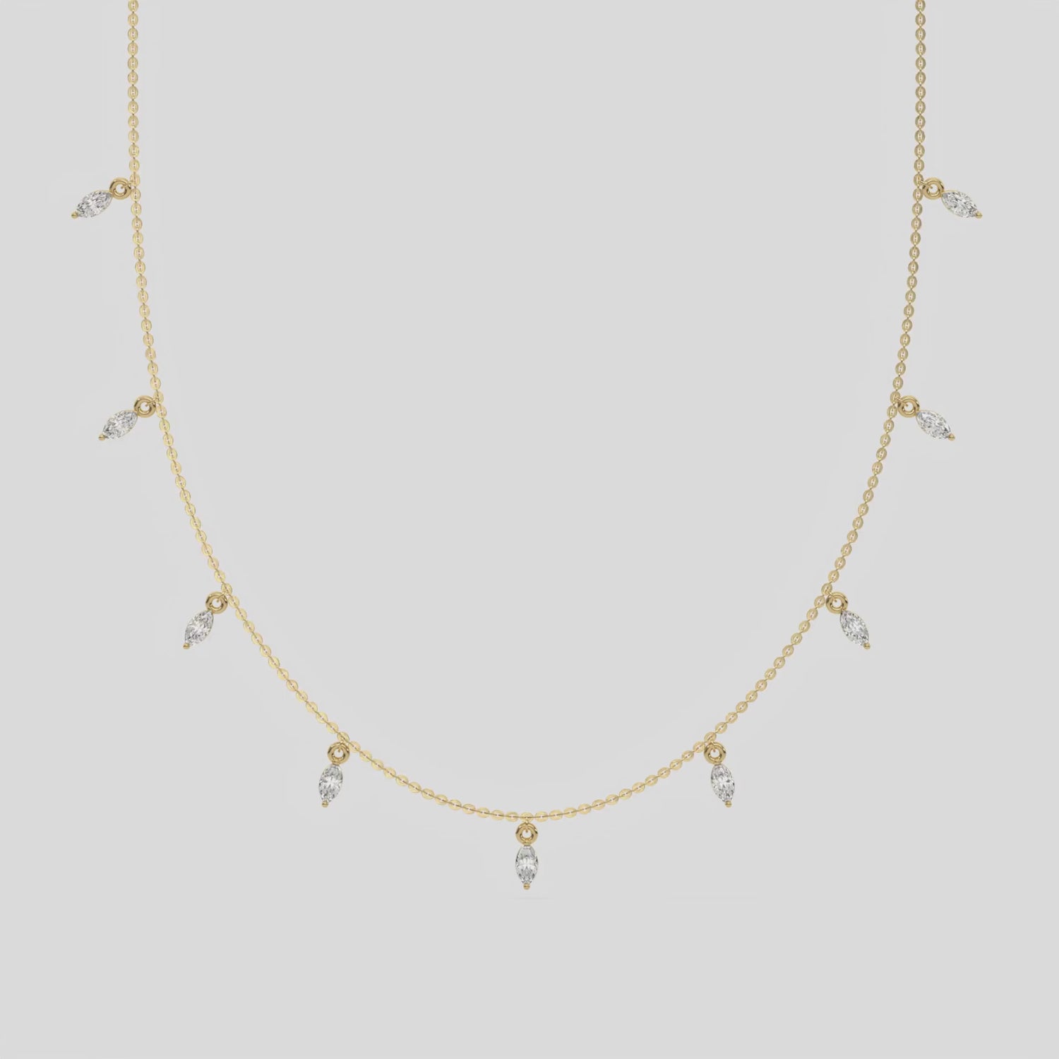 Marquise Dangling Diamond Necklace made with nine marquise cut diamonds each set in a prong setting, distributed evenly along the chain