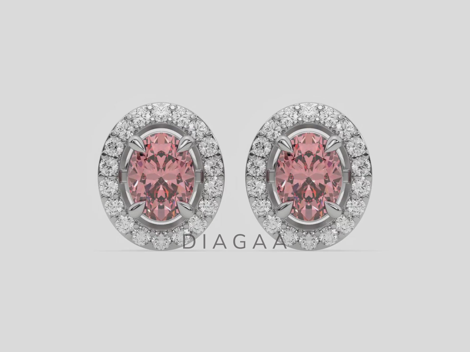 18k white gold Oval Diamond Halo Earrings made with an fancy pink oval cut solitaire diamonds set in a four prong setting