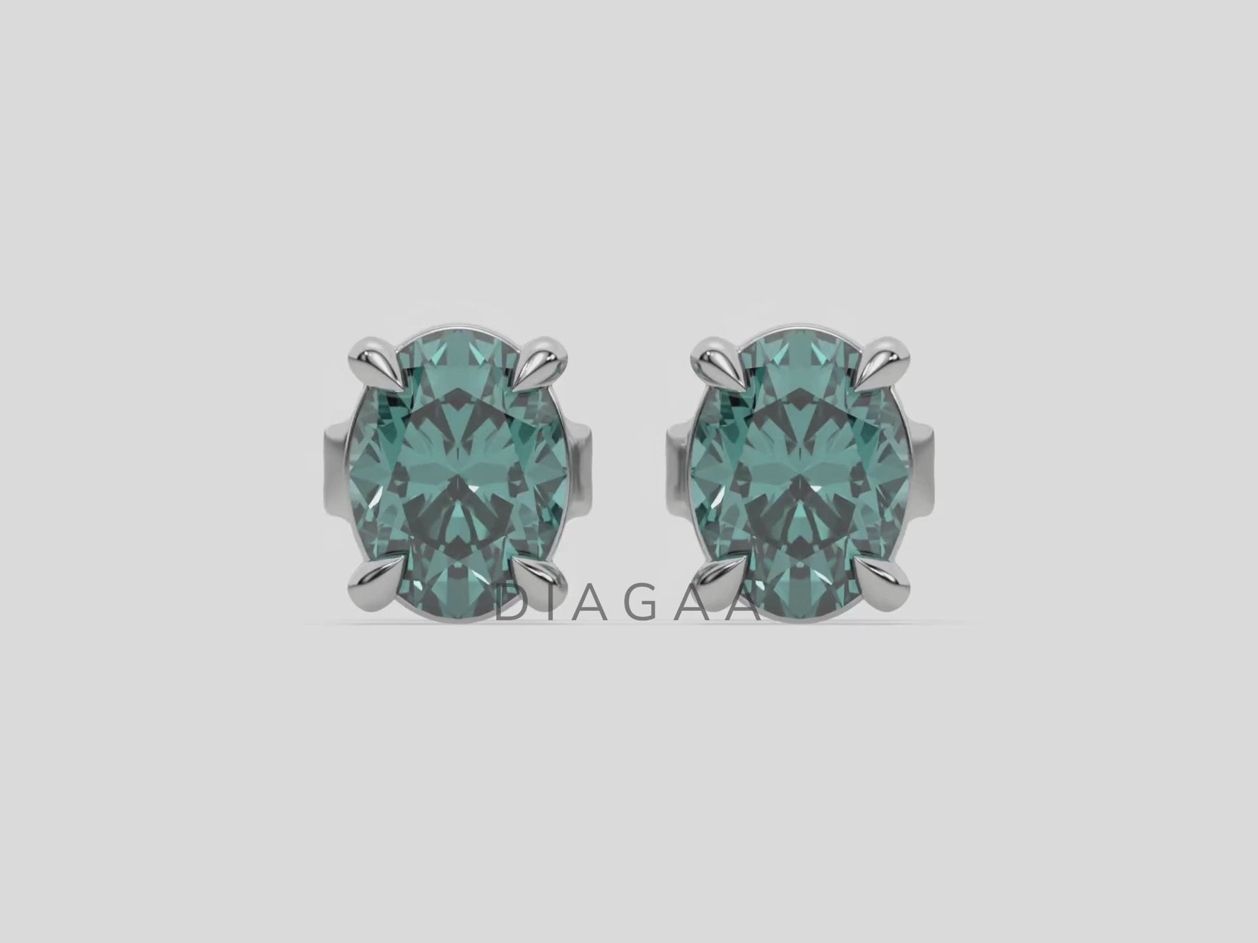 18k white gold Oval Diamond Earrings made with a fancy green oval cut diamond set in a four prong setting