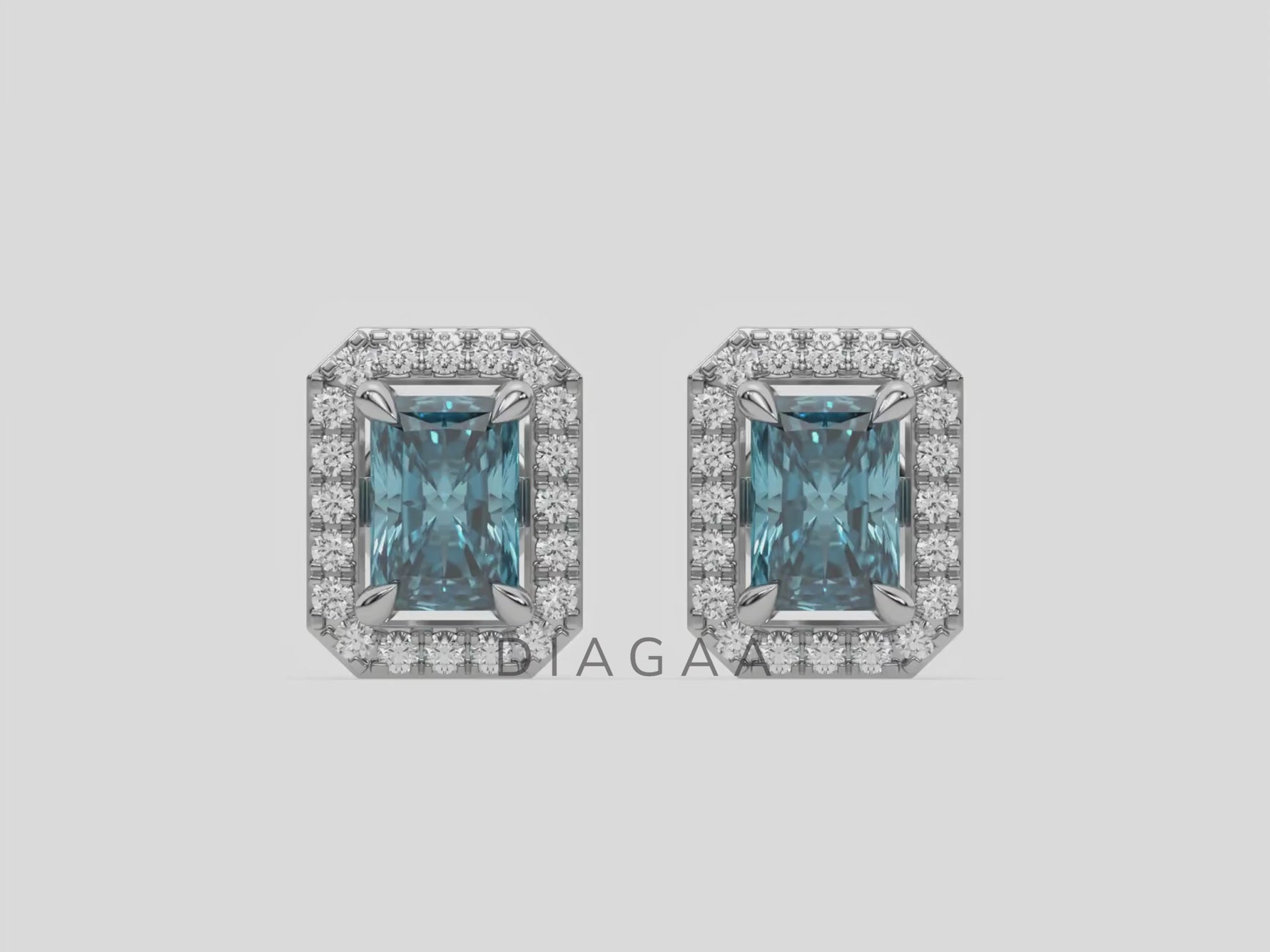 14k white gold Radiant Diamond Halo Earrings made with a fancy blue radiant cut solitaire diamond set in a four prong setting.