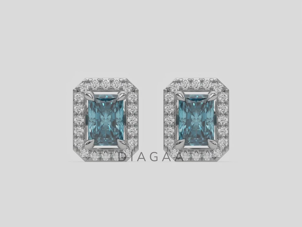 14k white gold Radiant Diamond Halo Earrings made with a fancy blue radiant cut solitaire diamond set in a four prong setting.