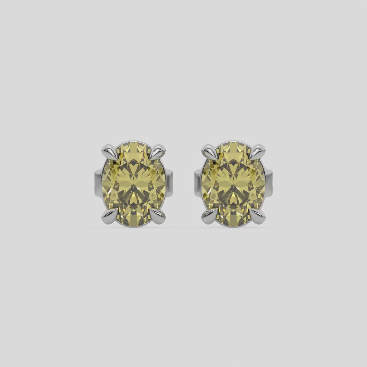 This video features a white gold Classic Oval Diamond Earrings made with an fancy yellow oval-cut diamonds set in a four prong setting