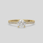 This video features a yellow gold ring is made with a round solitaire diamond set in four-prong setting 