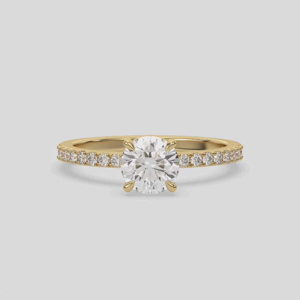 This video features a yellow gold ring is made with a round solitaire diamond set in four-prong setting 