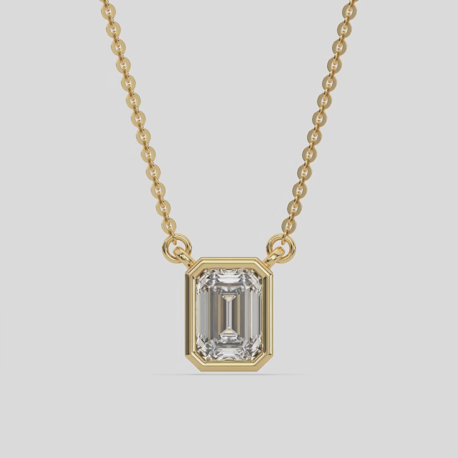 This yellow gold Emerald Solitaire Diamond Necklace made with an emerald cut diamond in bezel setting with adjustable chain 