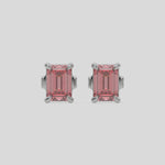 This video features a white gold Classic Emerald Diamond Earrings made with an fancy pink emerald-cut diamonds set in a four prong setting