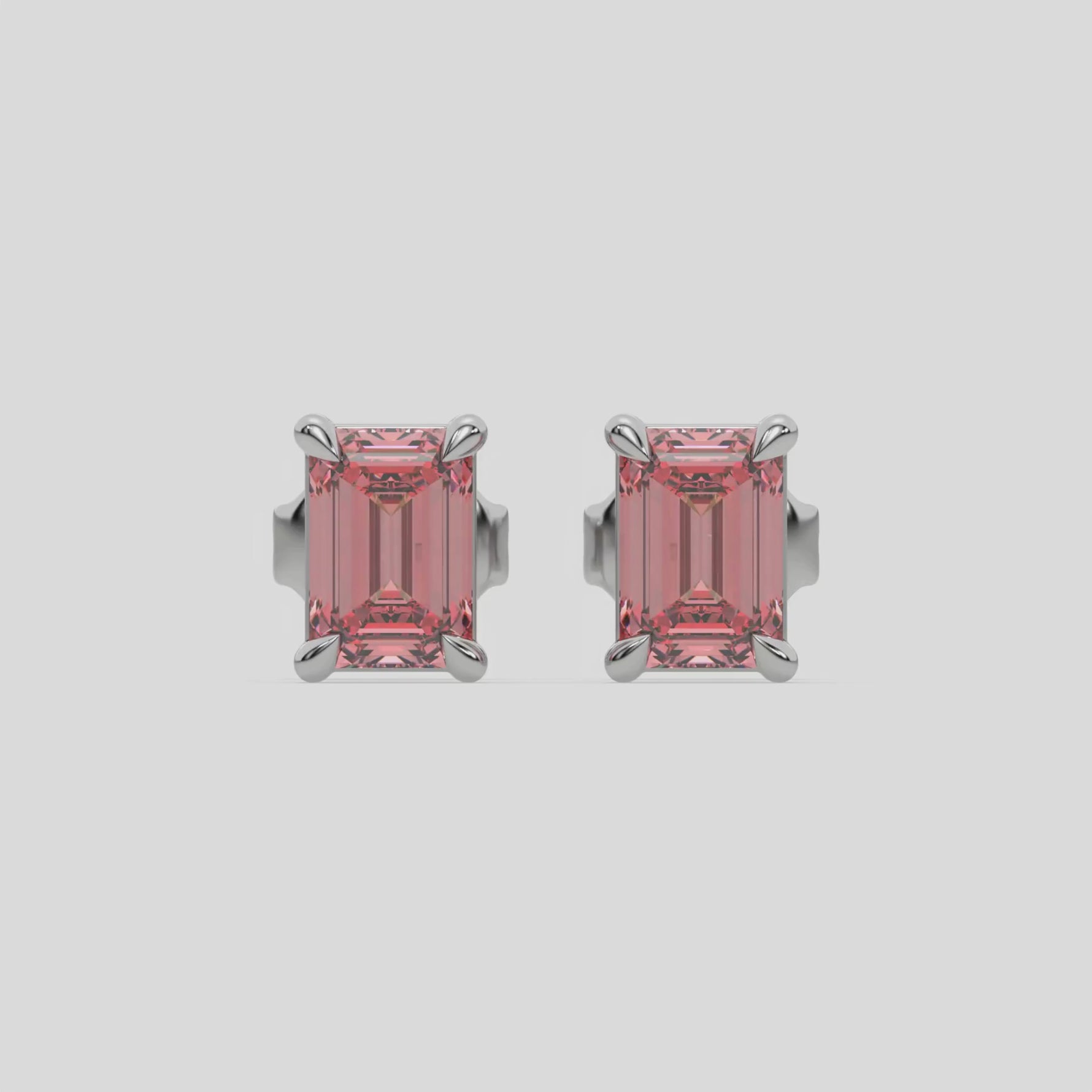 18k white gold Emerald Diamond Earrings made with an fancy pink emerald-cut diamond set in a four prong setting