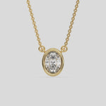 This yellow gold Oval Solitaire Diamond Necklace made with an oval cut diamond in bezel setting with adjustable chain 