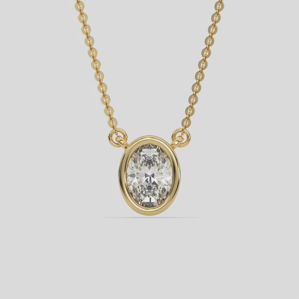 This yellow gold Oval Solitaire Diamond Necklace made with an oval cut diamond in bezel setting with adjustable chain 