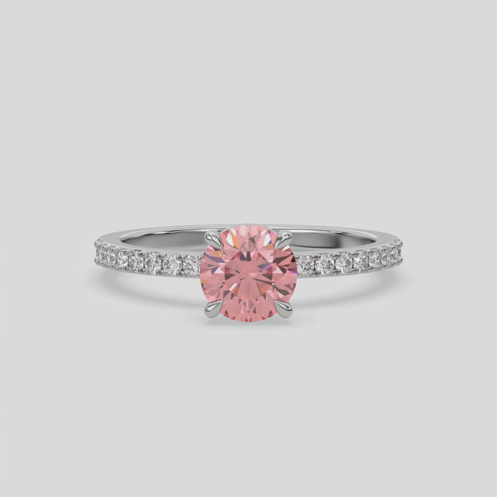 This video features a white gold ring is made with a fancy Pink round solitaire diamond set in four-prong setting