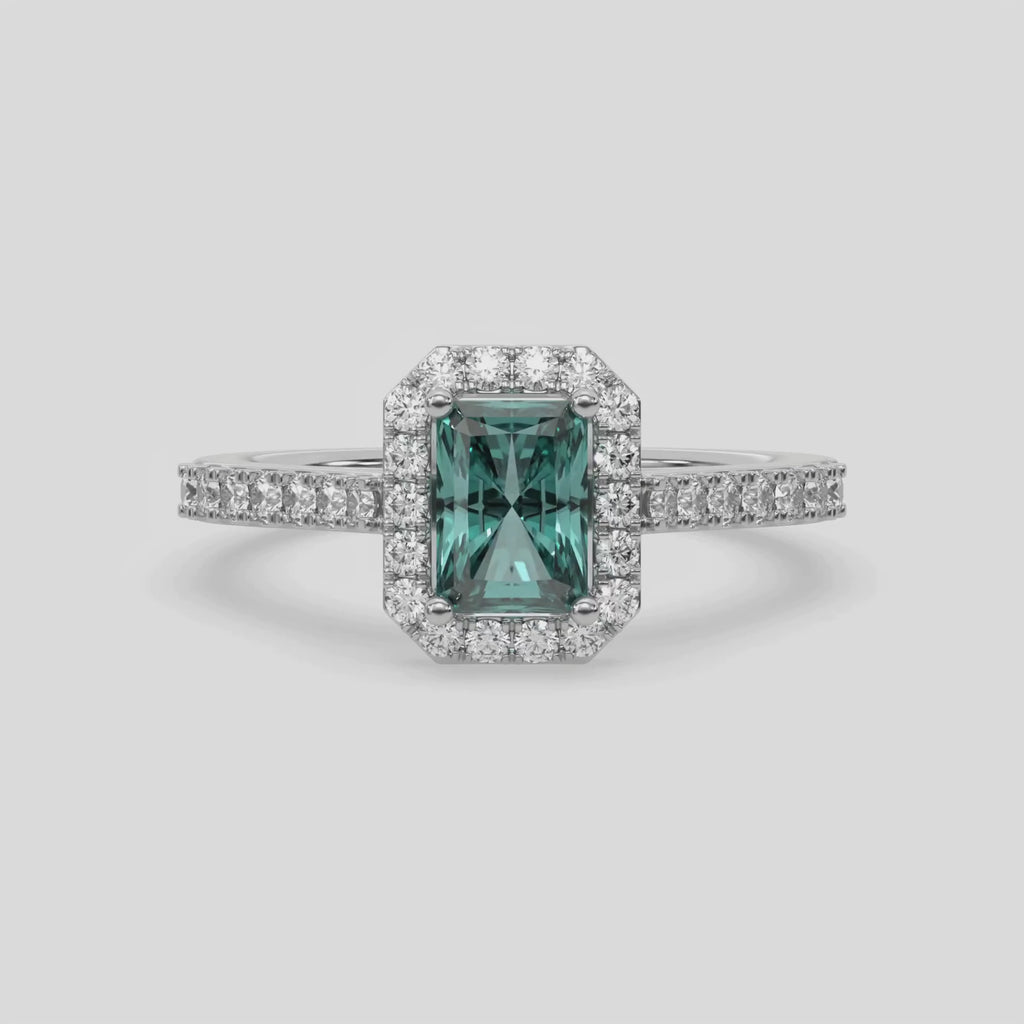 This video features a white gold Radiant Diamond Halo Engagement Ring is made with a fancy green radiant solitaire diamond set in a four-prong setting