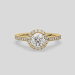 This video features a yellow gold Round Diamond Halo Engagement Ring is made with a round solitaire diamond set in a four-prong setting, surrounded by a halo of round diamonds all set on a pave band 