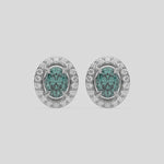 This video features a white gold Classic Oval Diamond Halo Earrings made with an fancy green oval cut solitaire diamonds set in a four prong setting