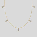 Oval Dangling Diamond Necklace made with five oval cut diamonds each set in a prong setting, distributed evenly along the chain