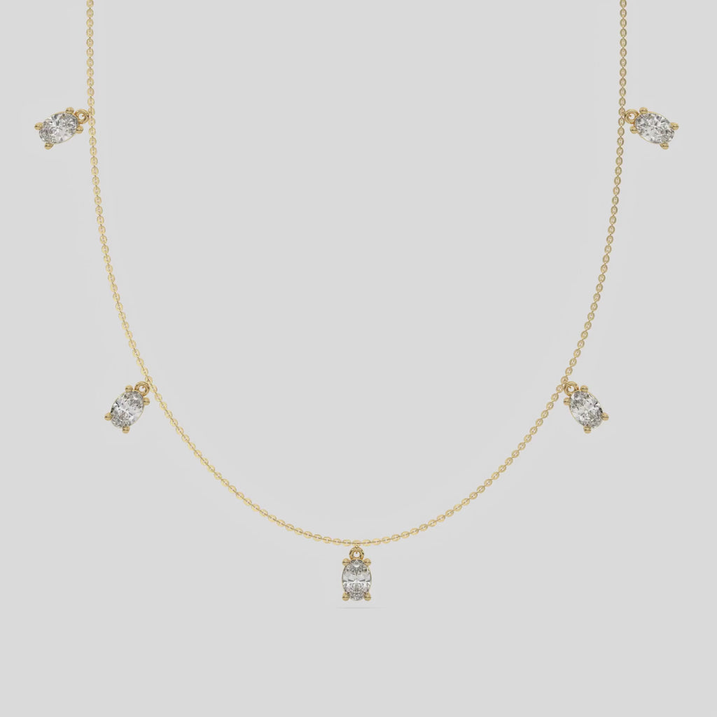 Oval Dangling Diamond Necklace made with five oval cut diamonds each set in a prong setting, distributed evenly along the chain