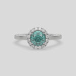 This video features a white gold ring features a fancy Green round solitaire diamond set in a four-prong setting