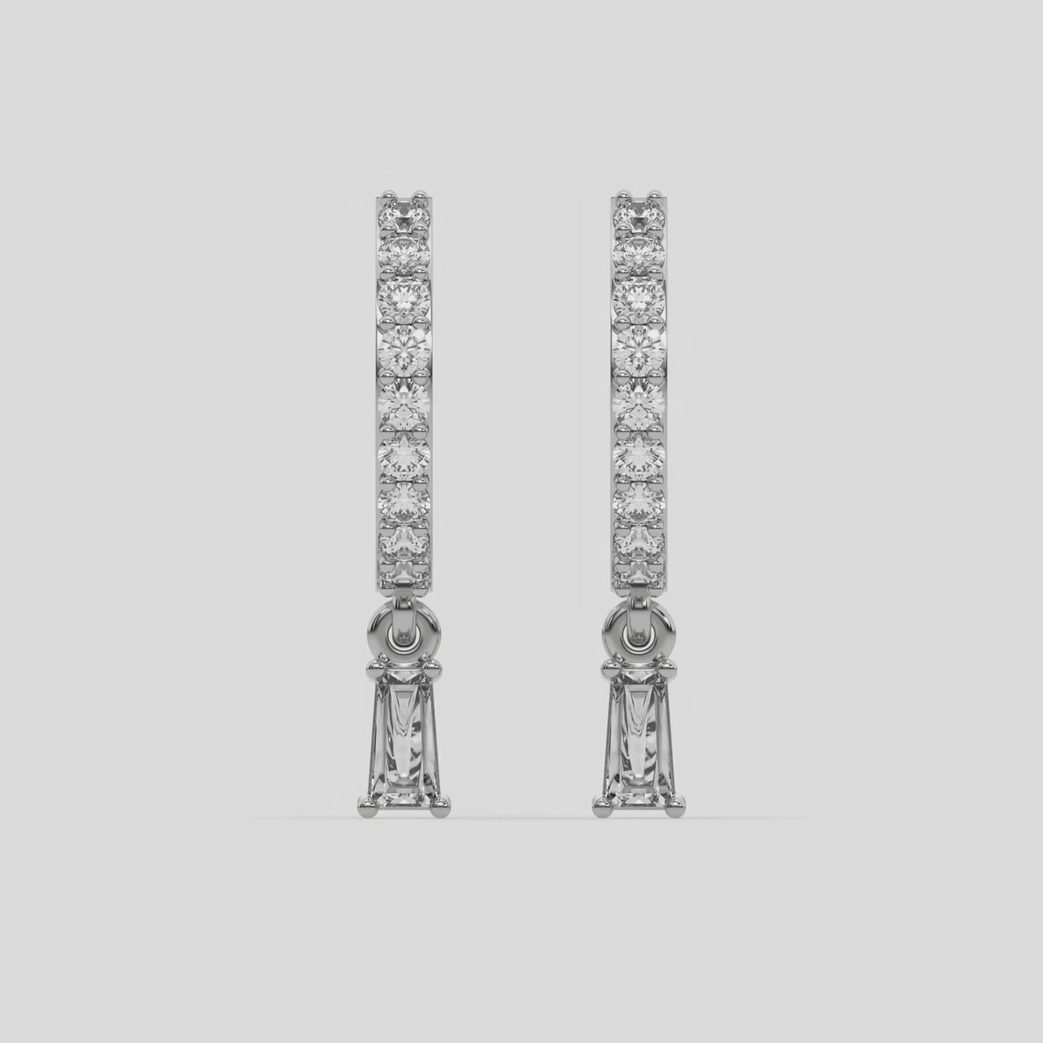 This video features a white gold Dangling Baguette Diamond Hoop Earrings handmade with round brilliant-cut diamonds in prong setting and a baguette solitaire hanging at the bottom