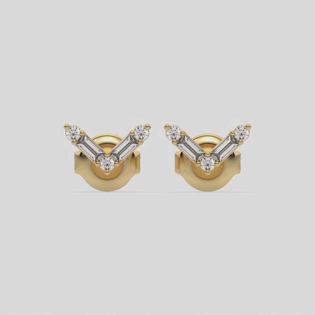 This video features a yellow gold Chevron Diamond Earrings made using baguette and round diamonds creating a v shaped design, securely set in shared prong setting